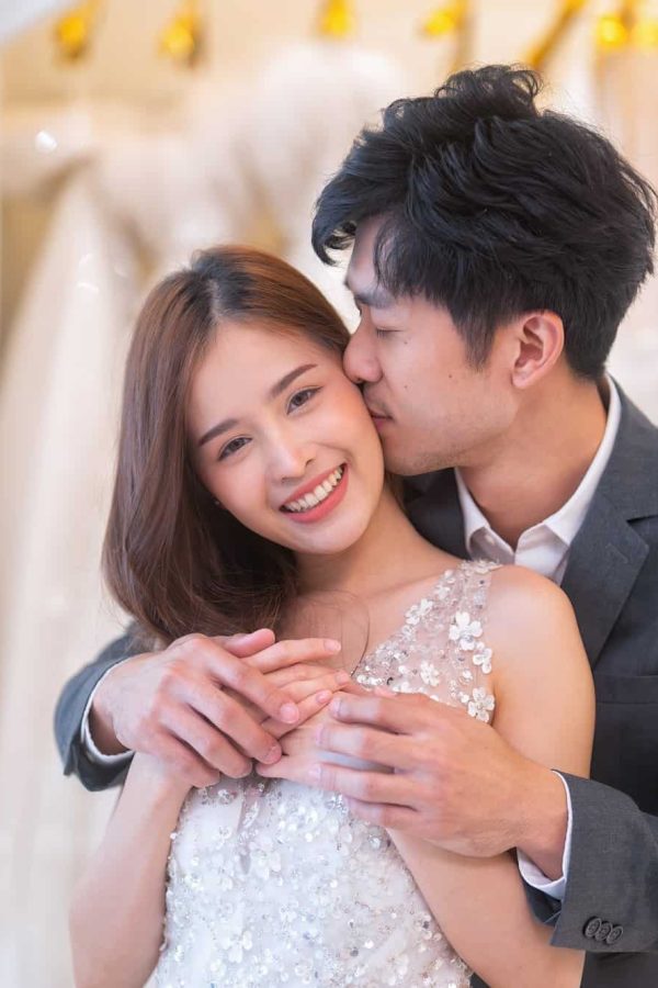 beautiful-young-brunette-love-couple-choosing-wedding-dress-in-a-bridal-salon-a-man-stand-hugging.jpg