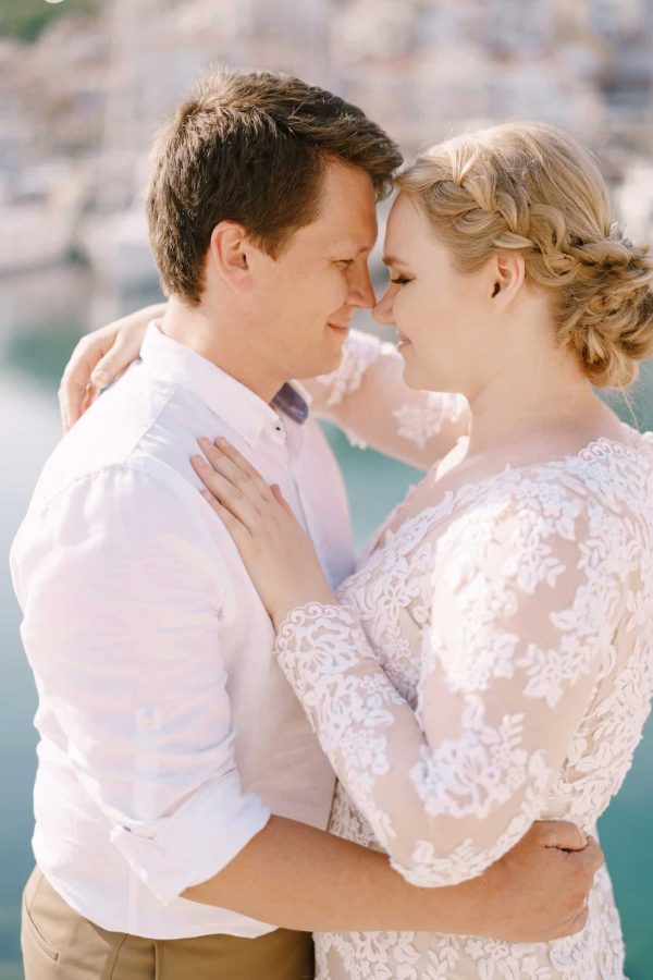 groom-hugs-bride-by-the-sea-portrait.jpg